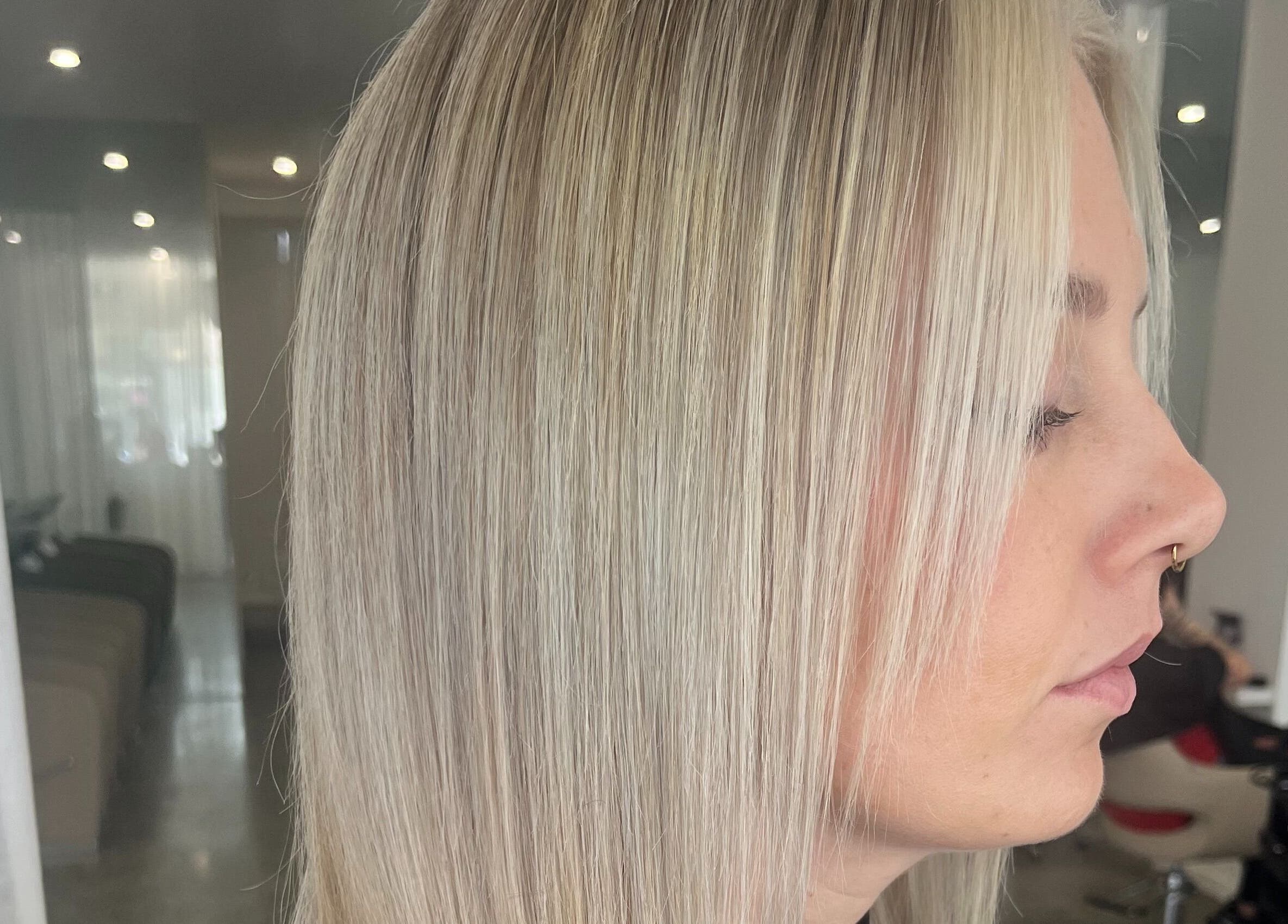 Sleek blonde hairstyle at Artistry Lane by Jessie Lee, Melbourne, Victoria, AU. Modern styling with smooth finish.
