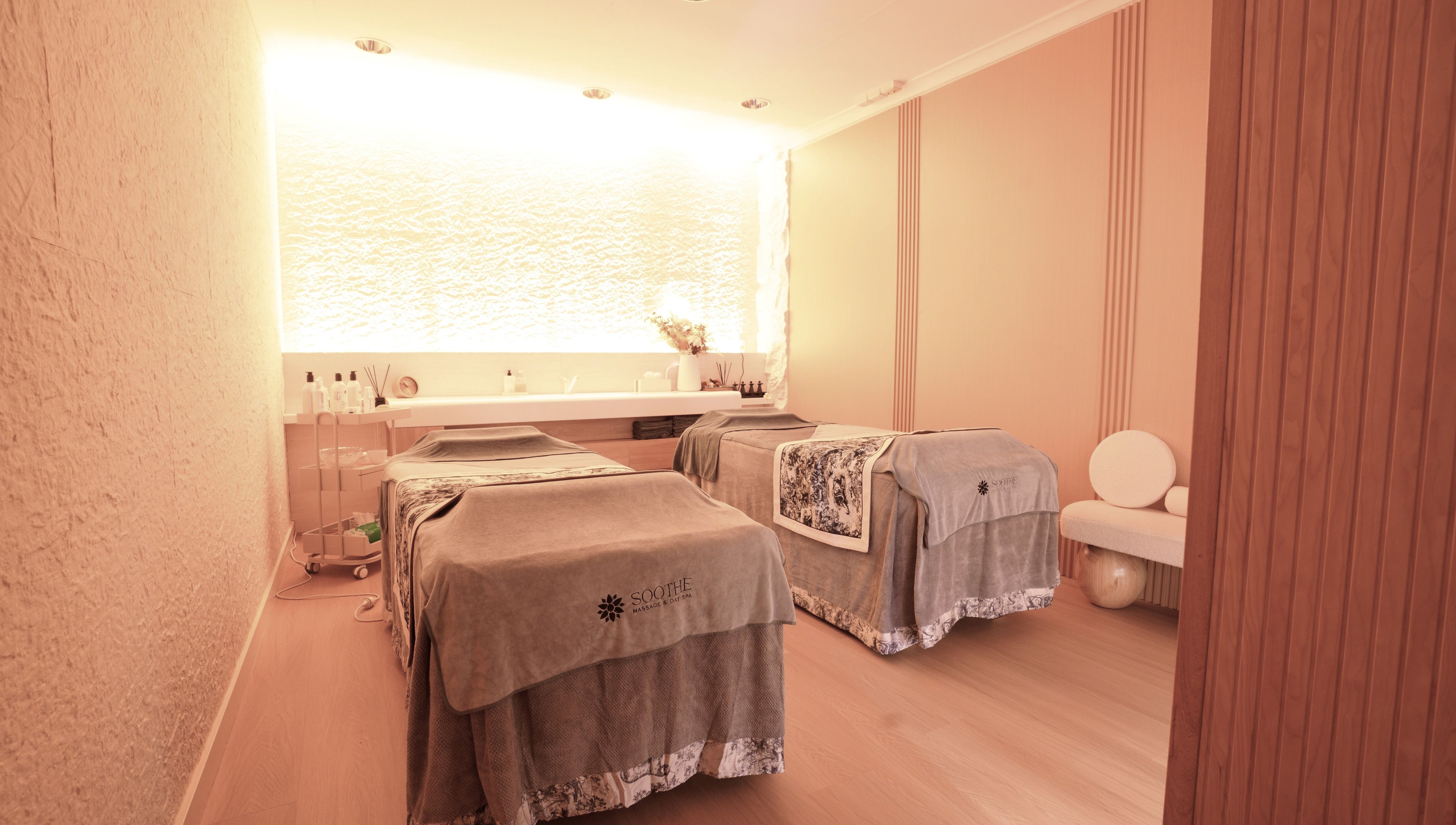 Relaxing massage room at Soothe Massage & Day Spa, Nedlands, Western Australia, AU. Cozy ambiance with two massage tables.