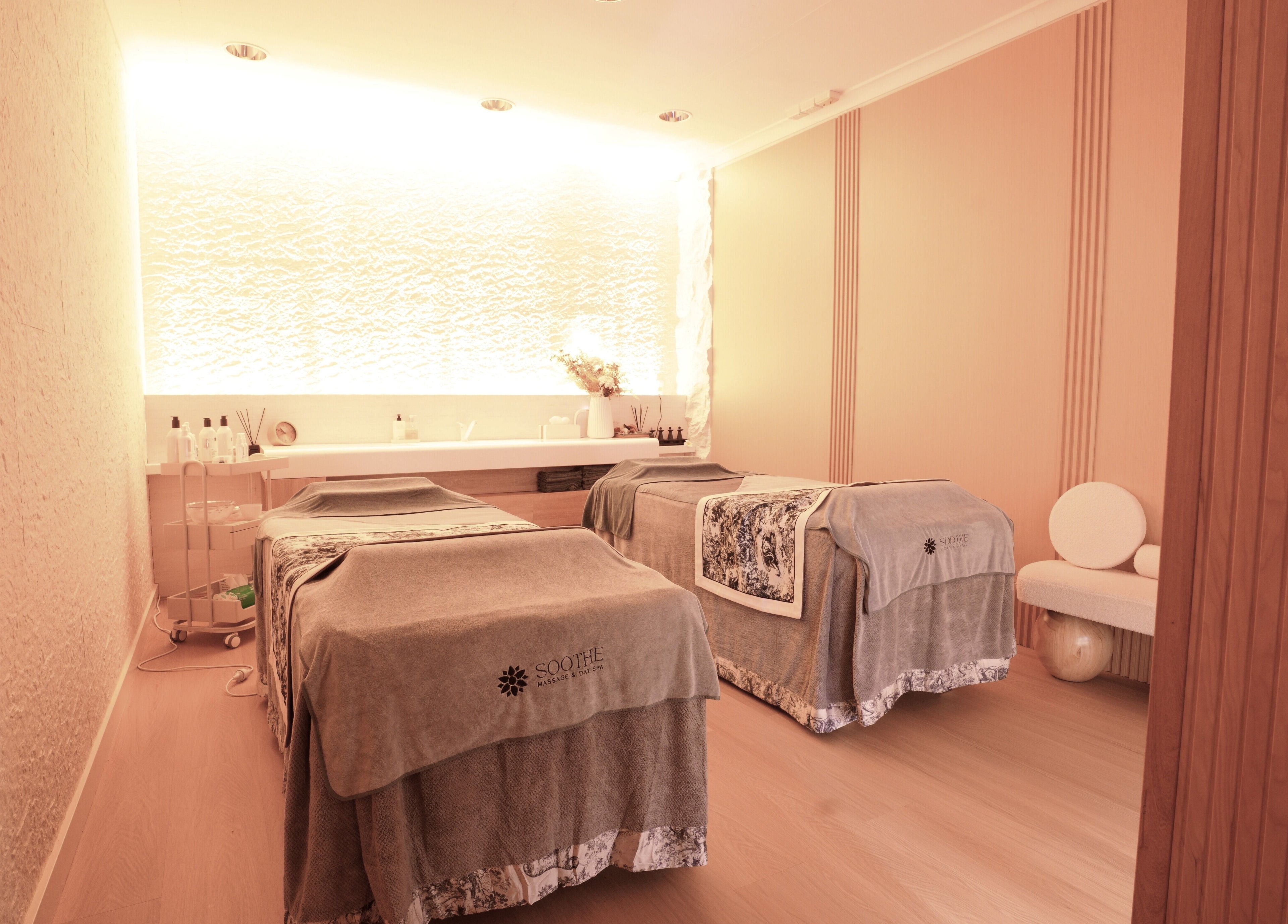 Relaxing massage room at Soothe Massage & Day Spa, Nedlands, Western Australia, AU. Cozy ambiance with two massage tables.