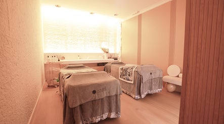 Relaxing massage room at Soothe Massage & Day Spa, Nedlands, Western Australia, AU. Cozy ambiance with two massage tables.
