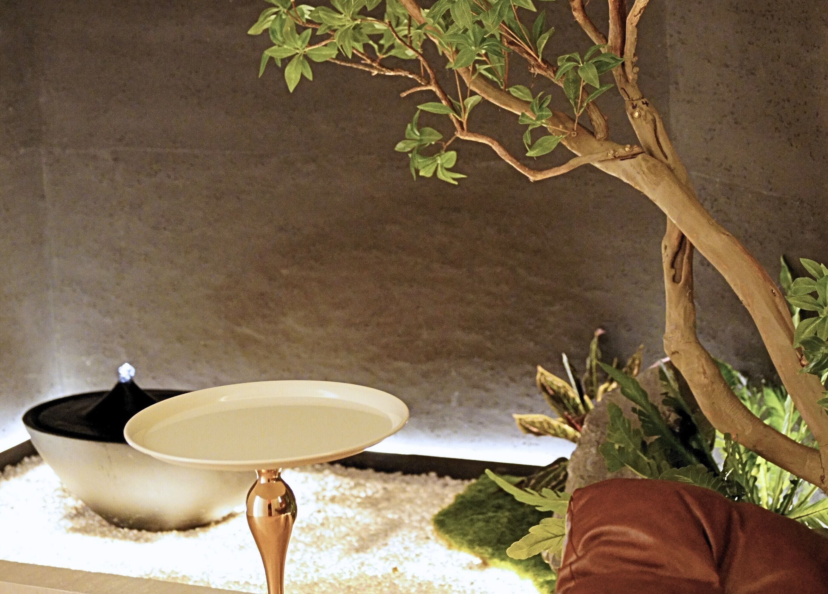 Serene corner with plants and white table at Soothe Massage & Day Spa, Nedlands, Western Australia, AU.