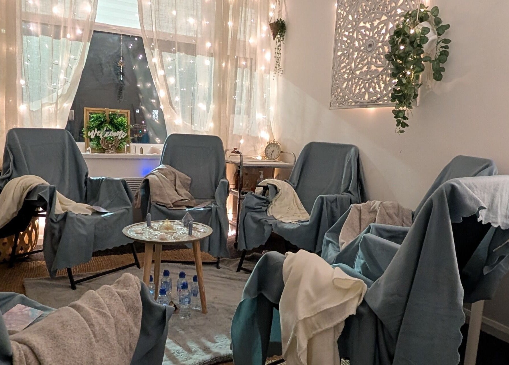 Cozy healing space at Anna Brown Intuitive Holistic Healing in Ossett, GB, with chairs, soft lights, and greenery.