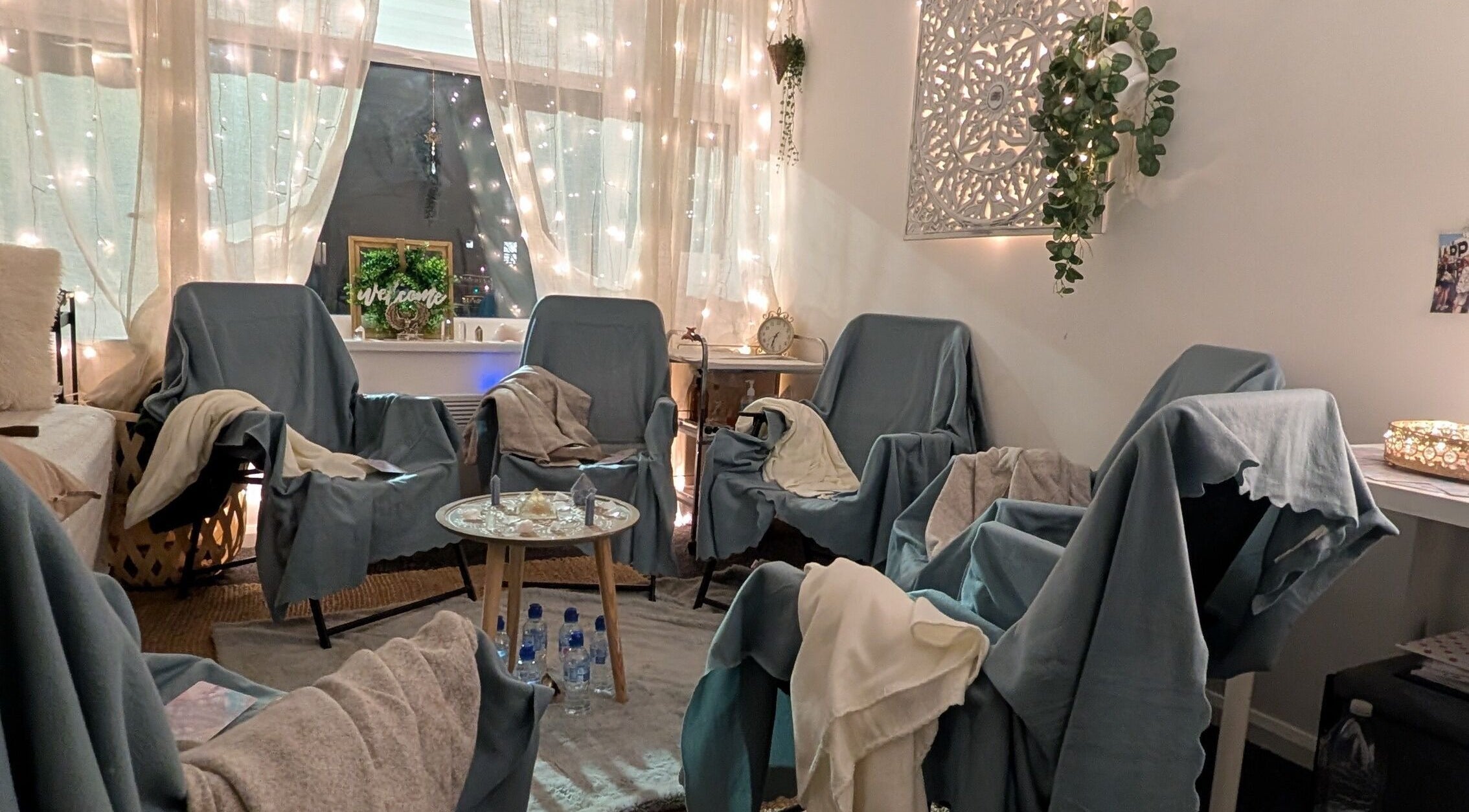 Cozy healing space at Anna Brown Intuitive Holistic Healing in Ossett, GB, with chairs, soft lights, and greenery.