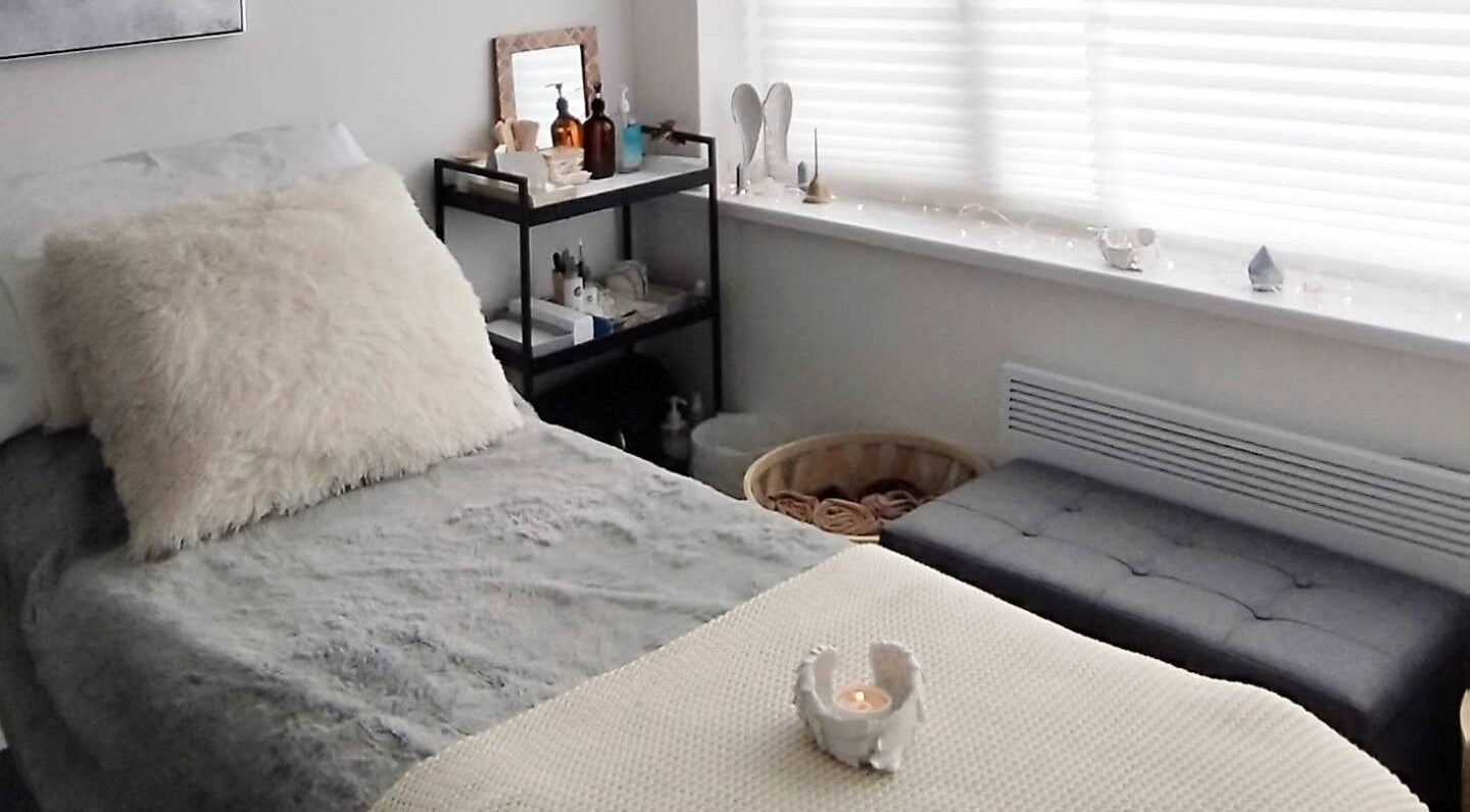 Serene therapy room at Anna Brown Intuitive Holistic Healing in Ossett, GB with plush bed and calming decor.
