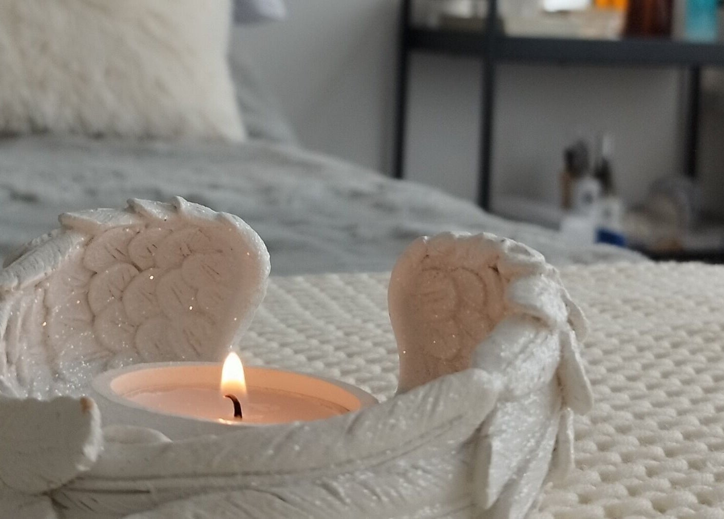 A lit candle in a decorative holder at Anna Brown Intuitive Holistic Healing, Ossett, GB.