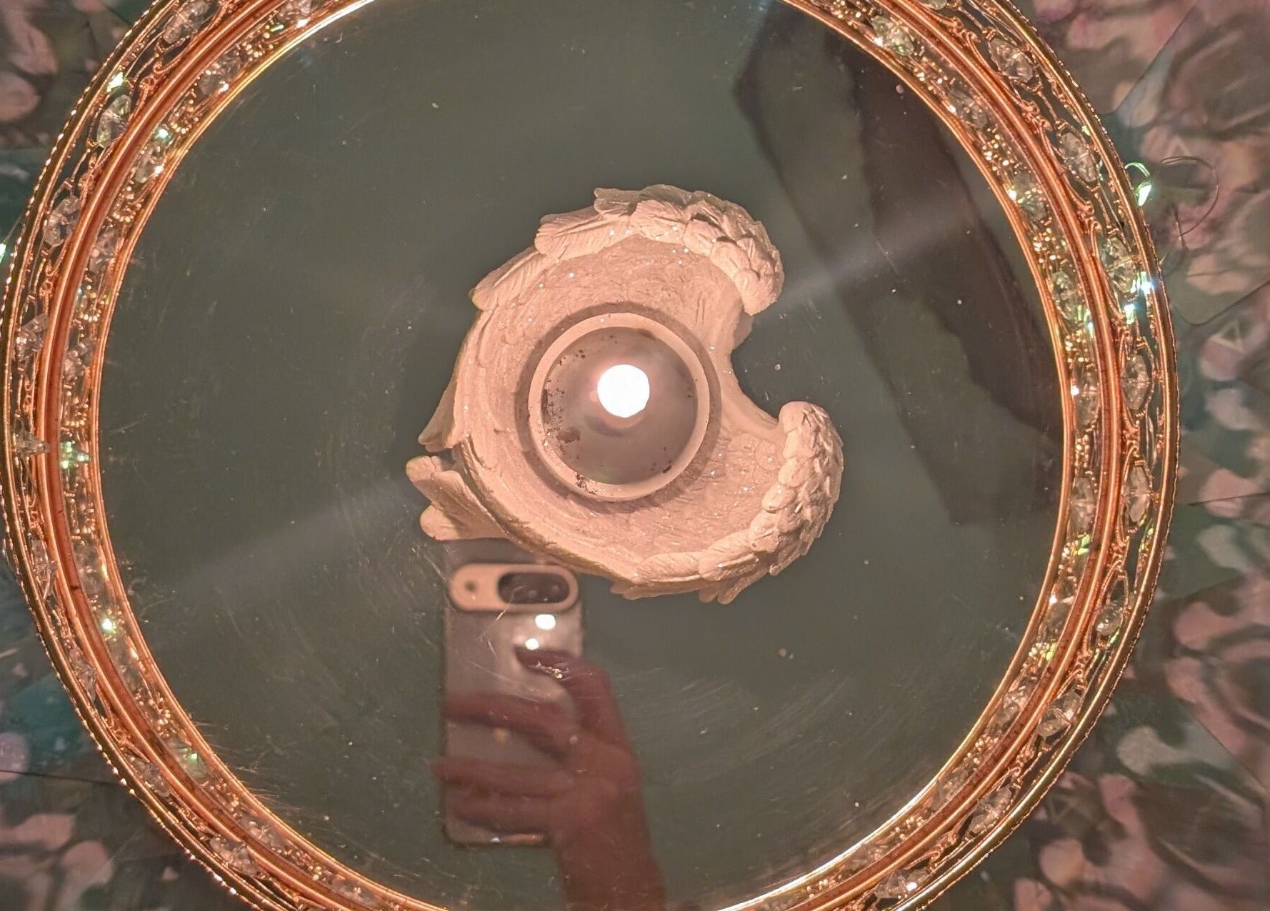 A candle on a decorative mirrored table at Anna Brown Intuitive Holistic Healing, Ossett, GB.