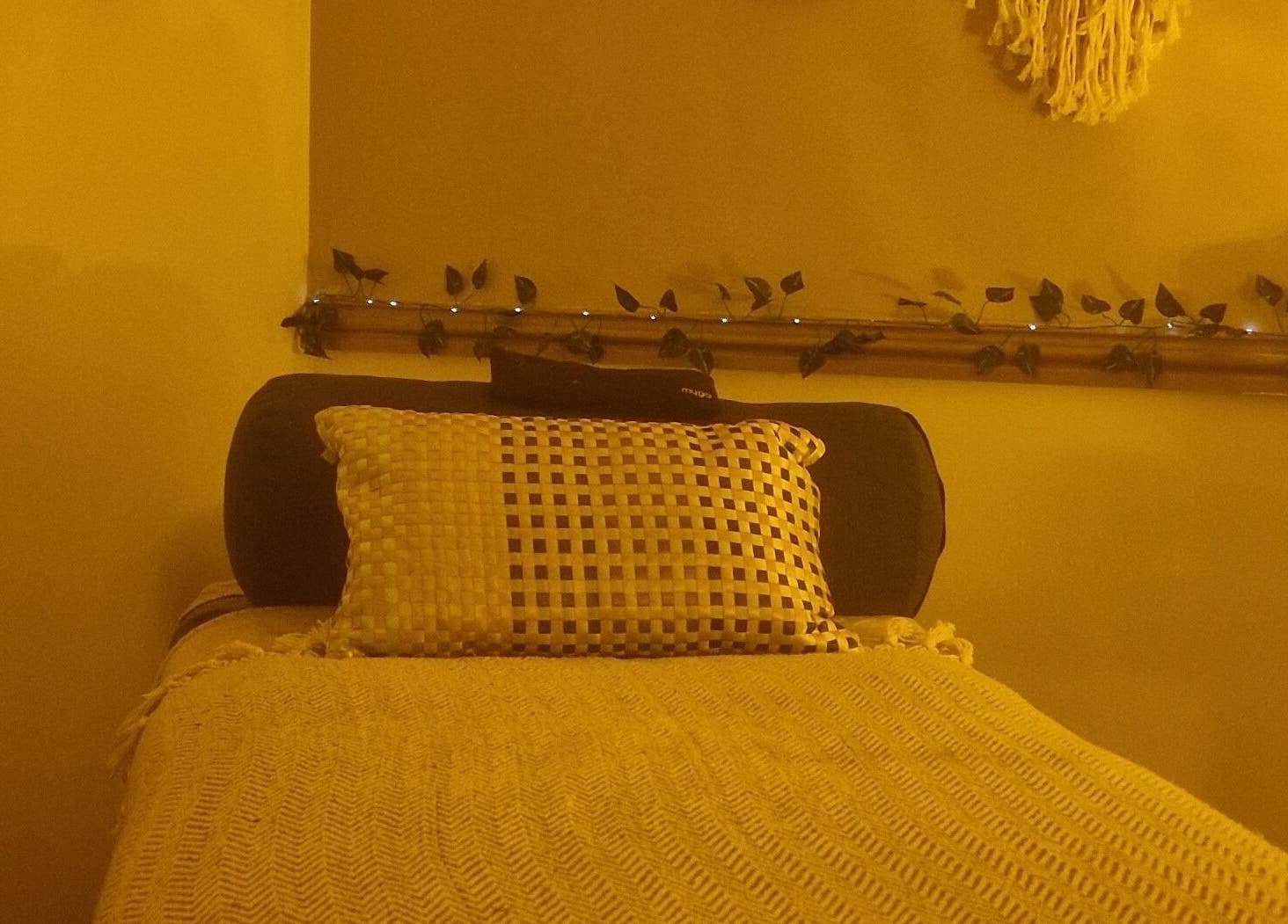 Cozy therapy room at Inner Peace Pathways, Stoke-on-Trent, England, GB with ambient lighting and comfortable bedding.