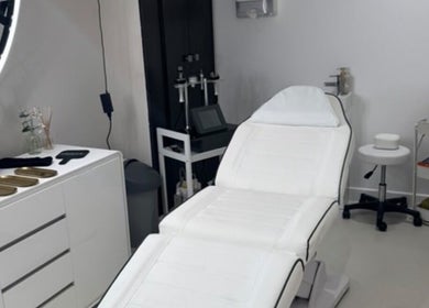 Modern treatment room at Aesthetics By Anna in Southport, England, GB, featuring a sleek white chair and beauty tools.