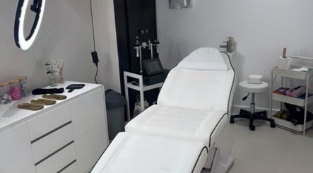 Modern treatment room at Aesthetics By Anna in Southport, England, GB, featuring a sleek white chair and beauty tools.