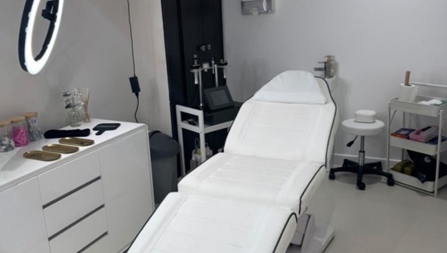 Modern treatment room at Aesthetics By Anna, Southport, England, GB with white therapy bed and tools.