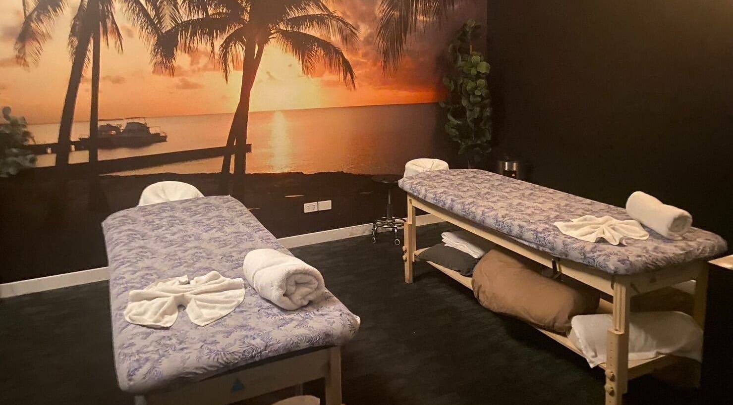 Relaxing massage room at GC Massage and Beauty Runaway Bay, Queensland, AU with sunset mural.