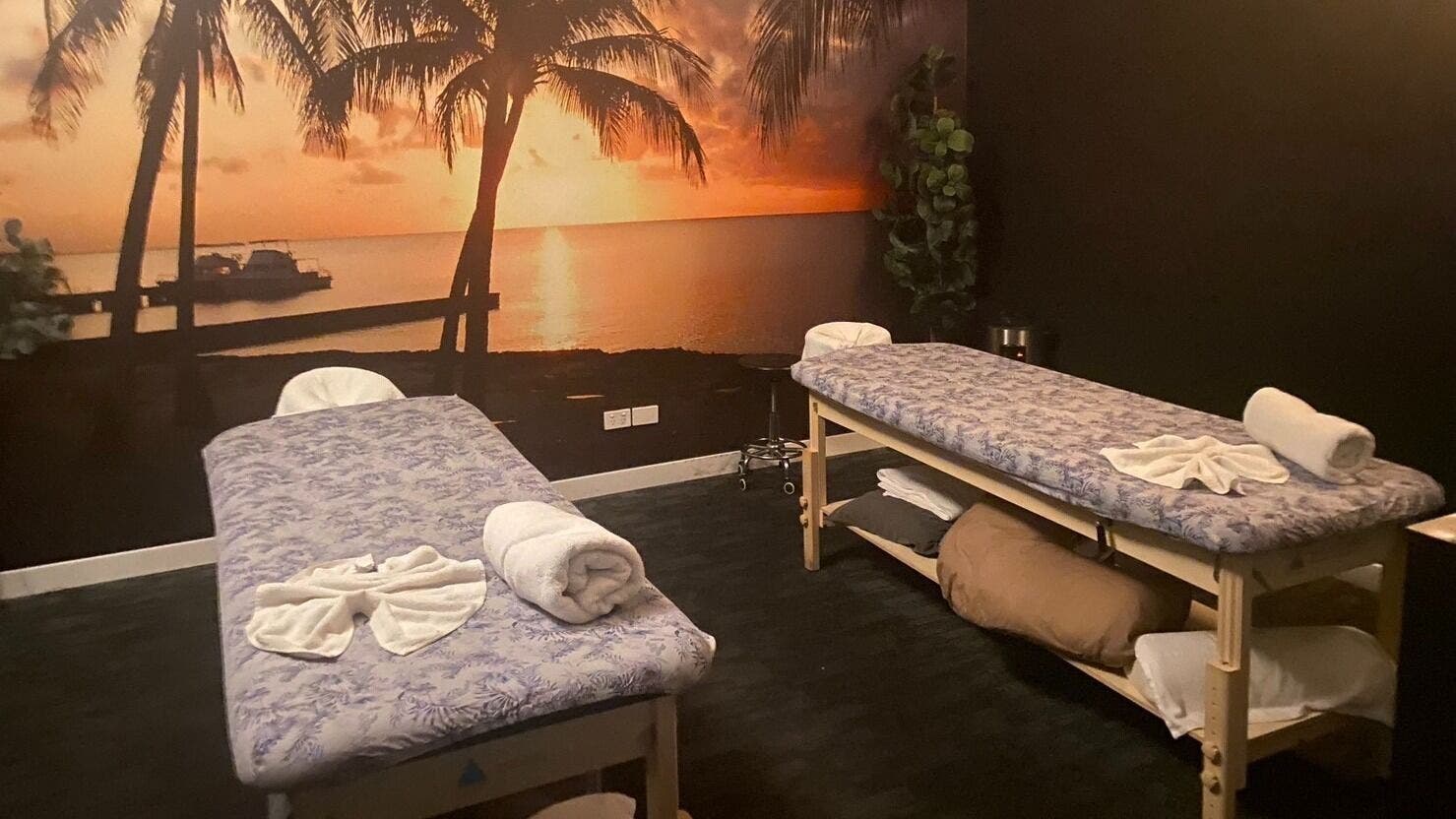 Relaxing massage room at GC Massage and Beauty Runaway Bay, Queensland, AU with sunset mural.