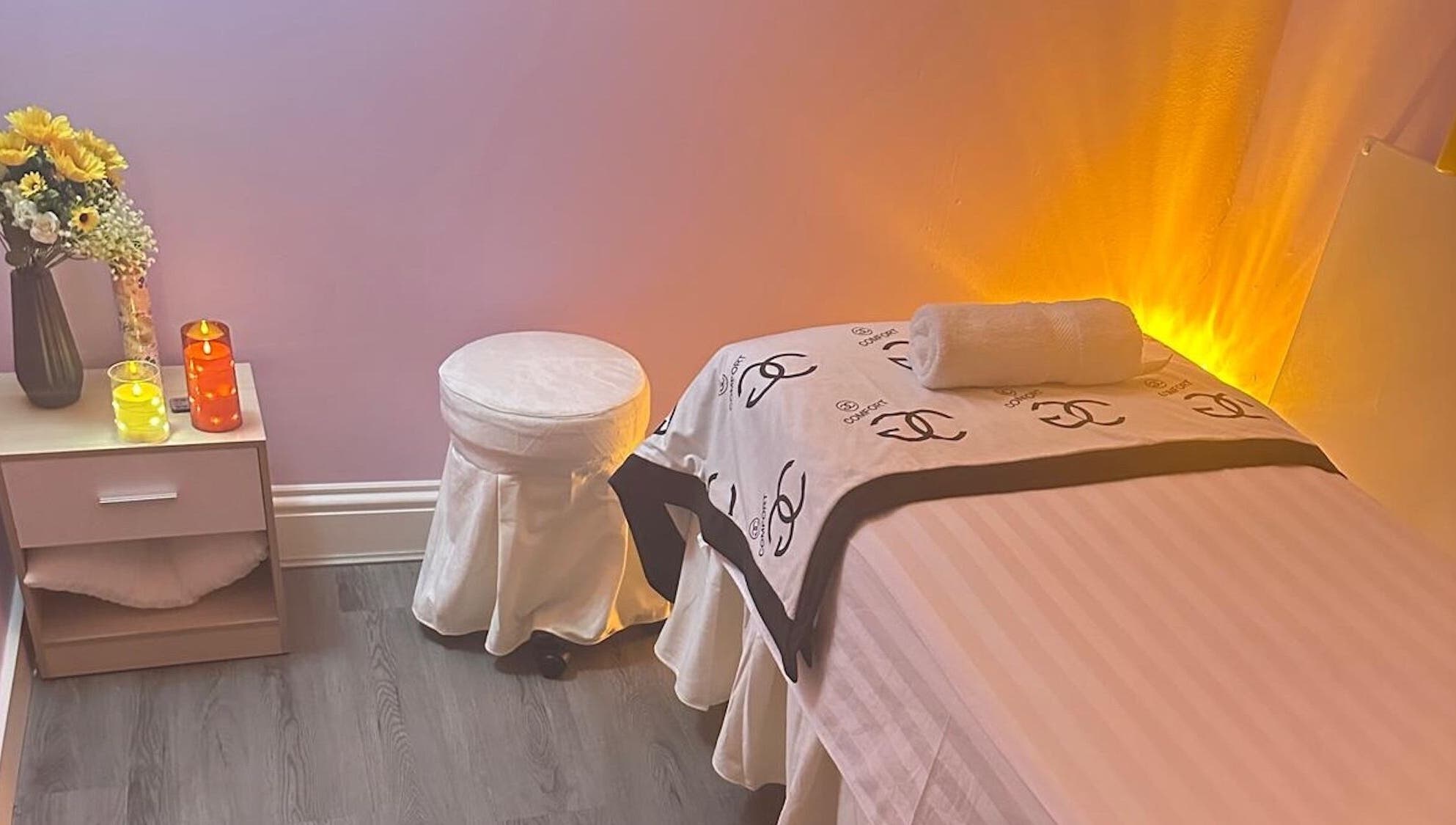 Serene spa room at Yo Spa, London, England, GB with ambient lighting and cozy massage table.