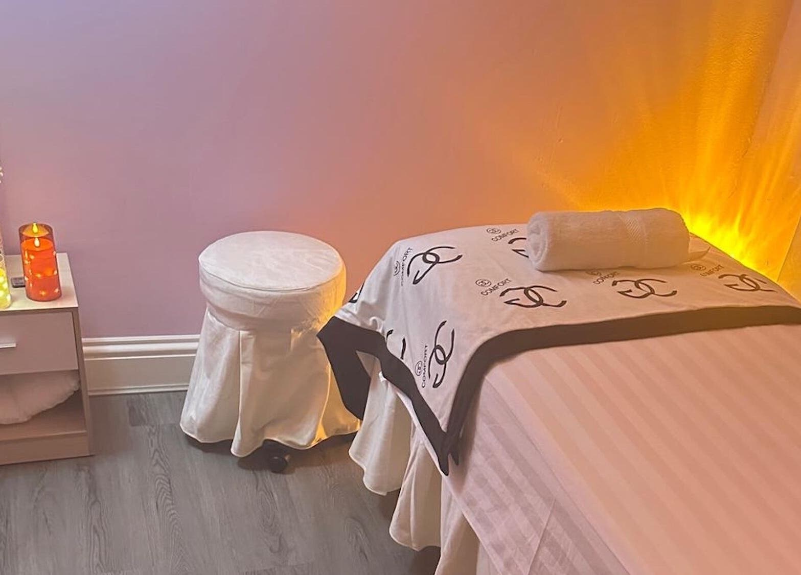 Serene spa room at Yo Spa, London, England, GB with ambient lighting and cozy massage table.