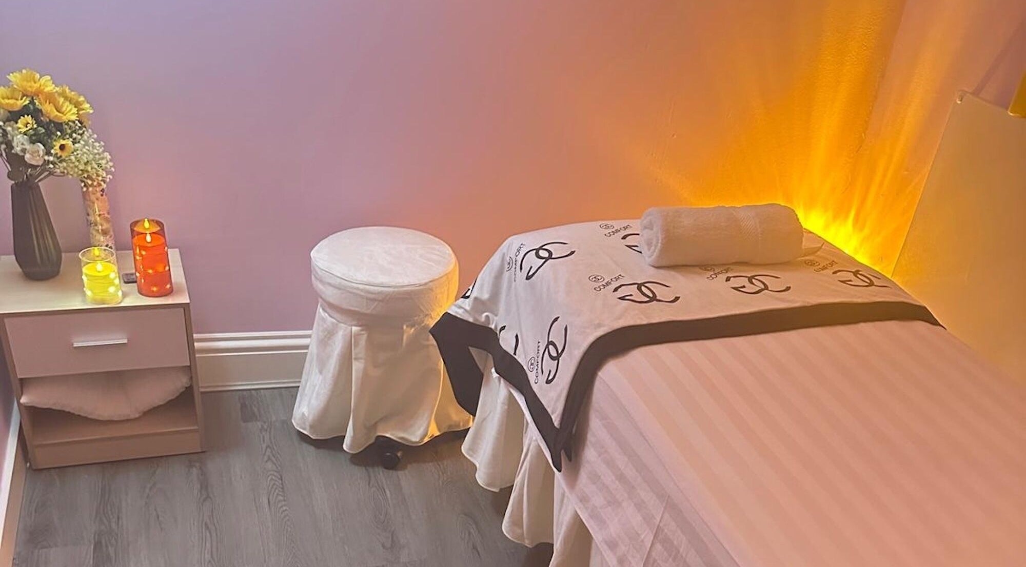 Serene spa room at Yo Spa, London, England, GB with ambient lighting and cozy massage table.