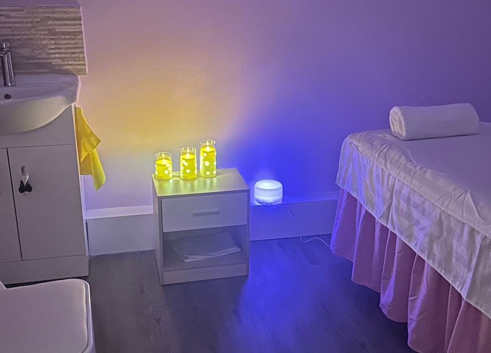 Relaxing massage room at Yo Spa, London, England, GB, with ambient lighting and candles.