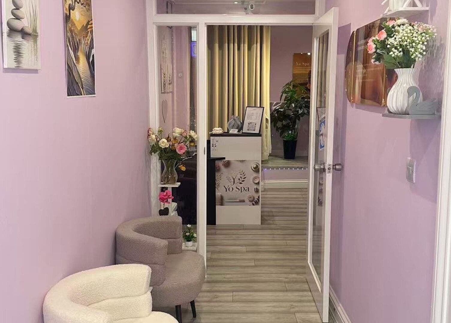 Inviting entrance of Yo Spa in London, England, GB with lavender walls and elegant decor.