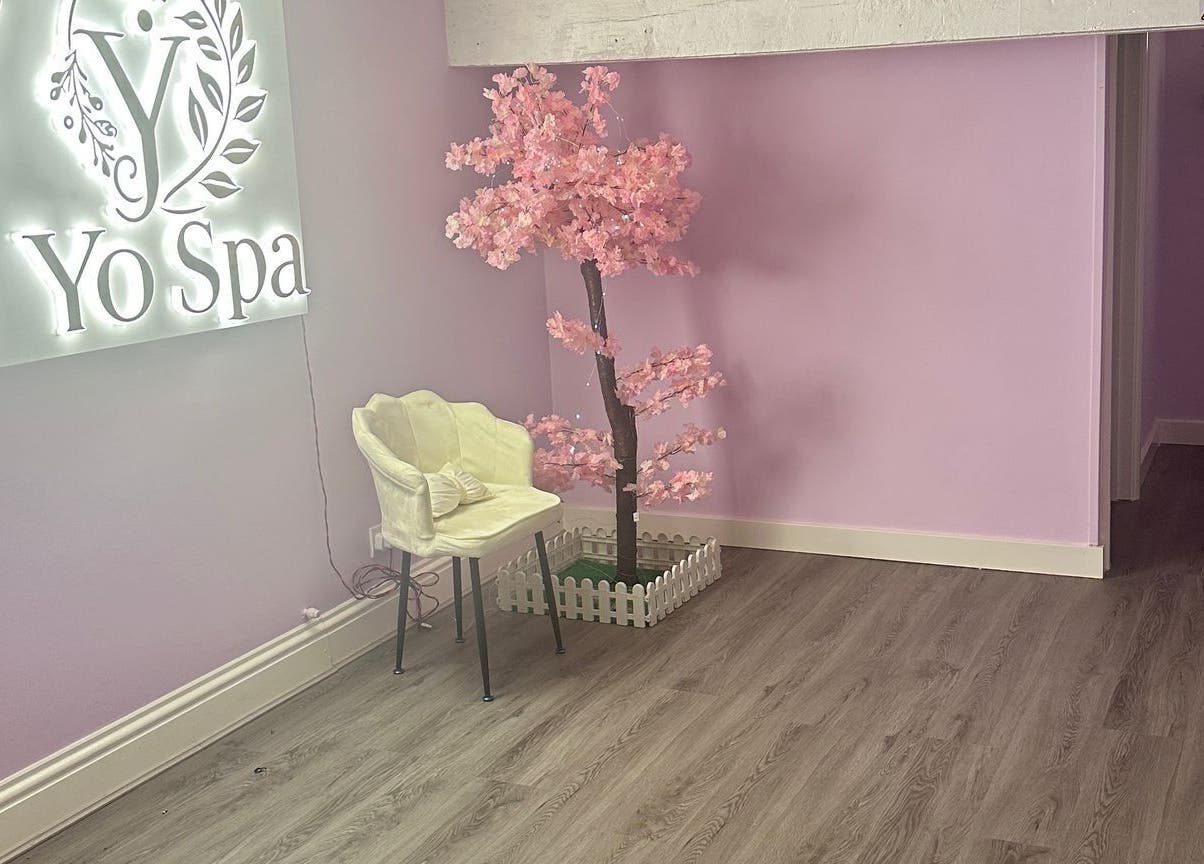 Calm corner at Yo Spa, London, England, GB featuring pastel walls and a delicate decorative tree.