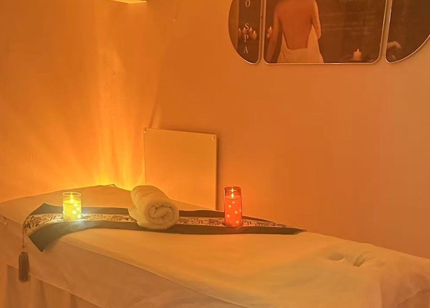 Cozy massage room at Yo Spa, London, England, GB, featuring soft lighting and a relaxing ambiance.