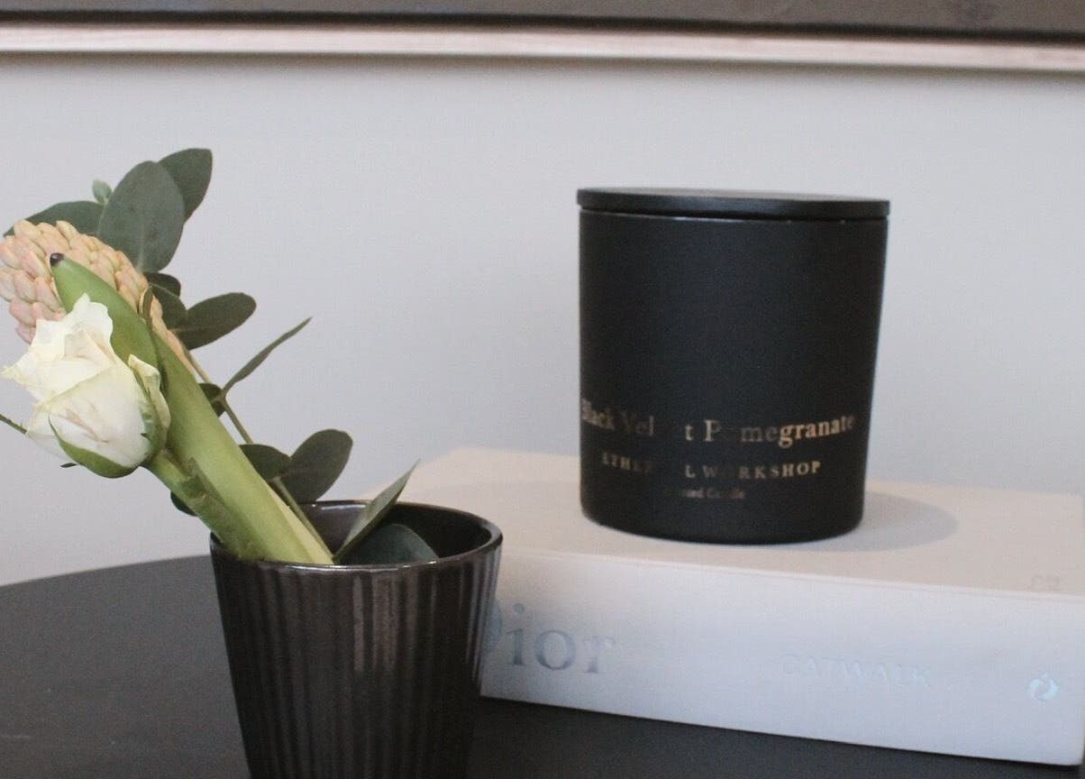 Elegant decor at Polished Harrogate, Harrogate, England, GB. Features a white rose and candle on a book.