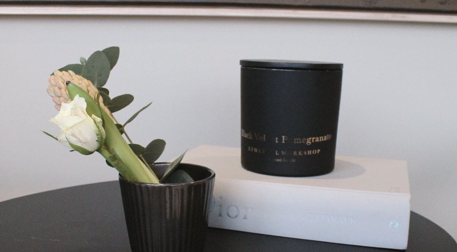 Elegant decor at Polished Harrogate, Harrogate, England, GB. Features a white rose and candle on a book.