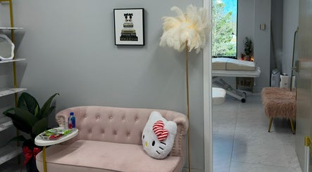 Elegant waiting area at Beauty Blossom, Woodbridge, Virginia, US, featuring a plush sofa and a whimsical decor.