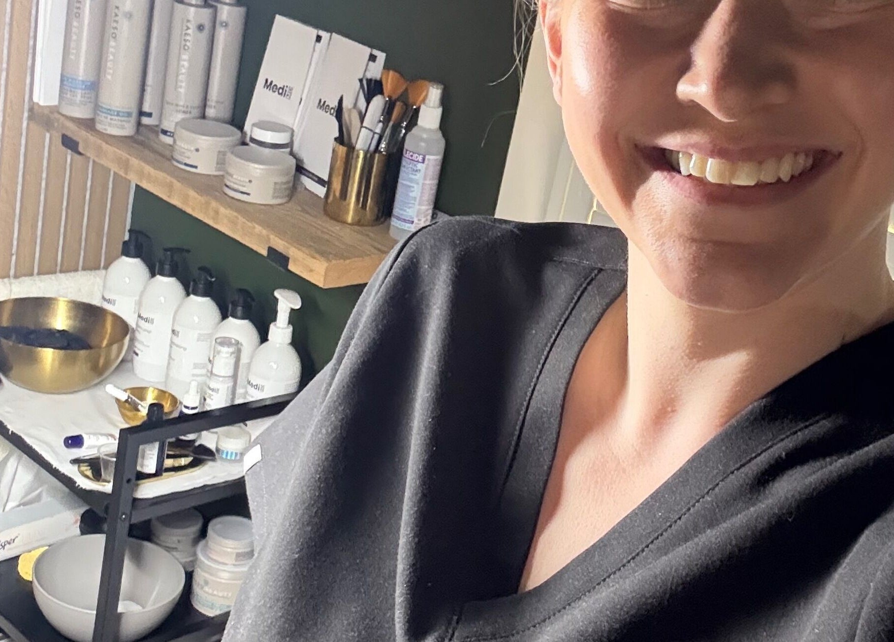 Friendly staff at Glow and Renew Skincare, Ash, England, GB, amidst premium skincare products.