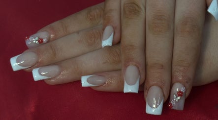 Elegant nail art featuring French tips and floral details at Cherry Aura Nails, Nottingham, England, GB.