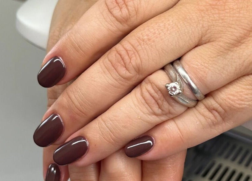 Freshly manicured nails at Studio 10 Beauty Boreham, Chelmsford, England, GB, showcasing glossy dark polish.