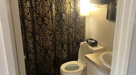 Elegant restroom at Divine Dahlia Beauty, Agoura Hills, California, US with ornate curtain and modern fixtures.