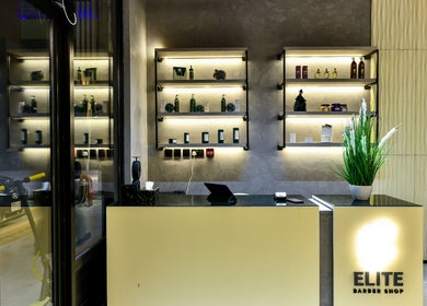 Reception area of L8 Elite Barbershop, Riyadh, Riyadh Province, SA, showcasing modern shelves and elegant design.