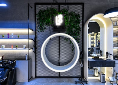 Modern interior of L8 Elite Barbershop, Riyadh, featuring sleek design and lighting elements.
