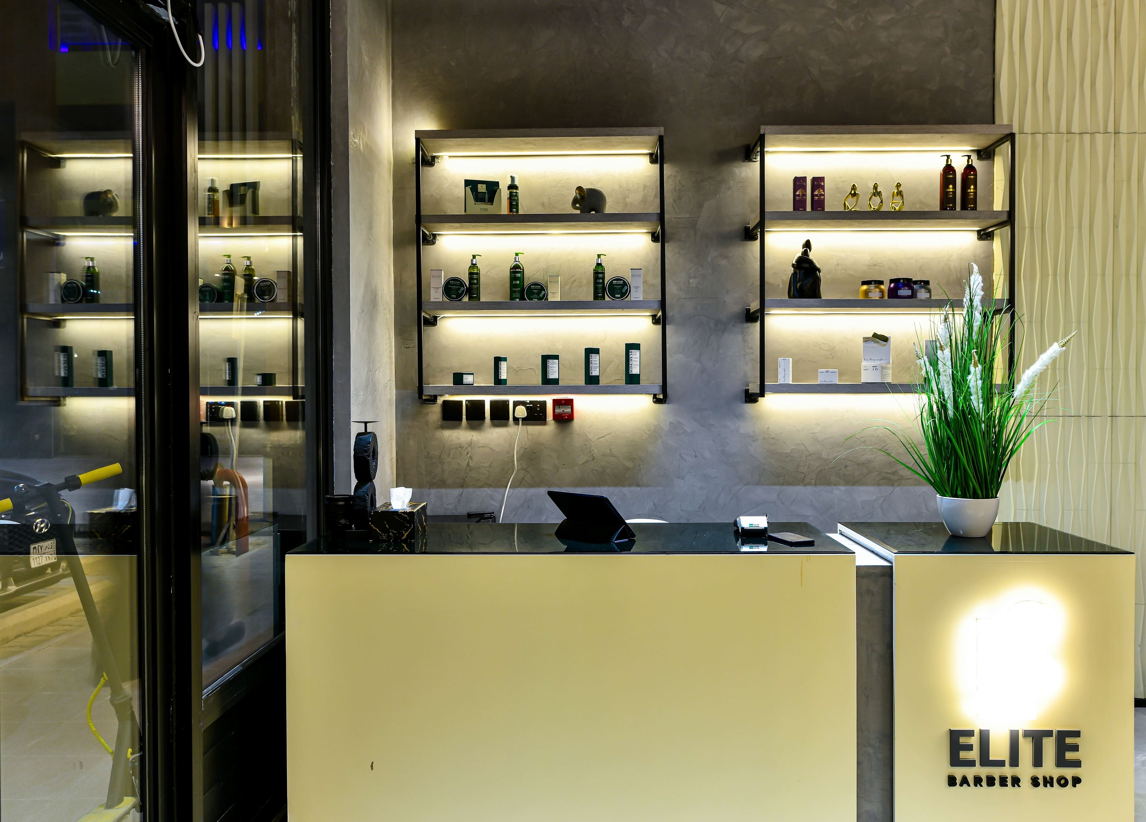 Modern interior of L8 Elite Barbershop in Riyadh, Riyadh Province, SA showcasing stylish shelving and decor.