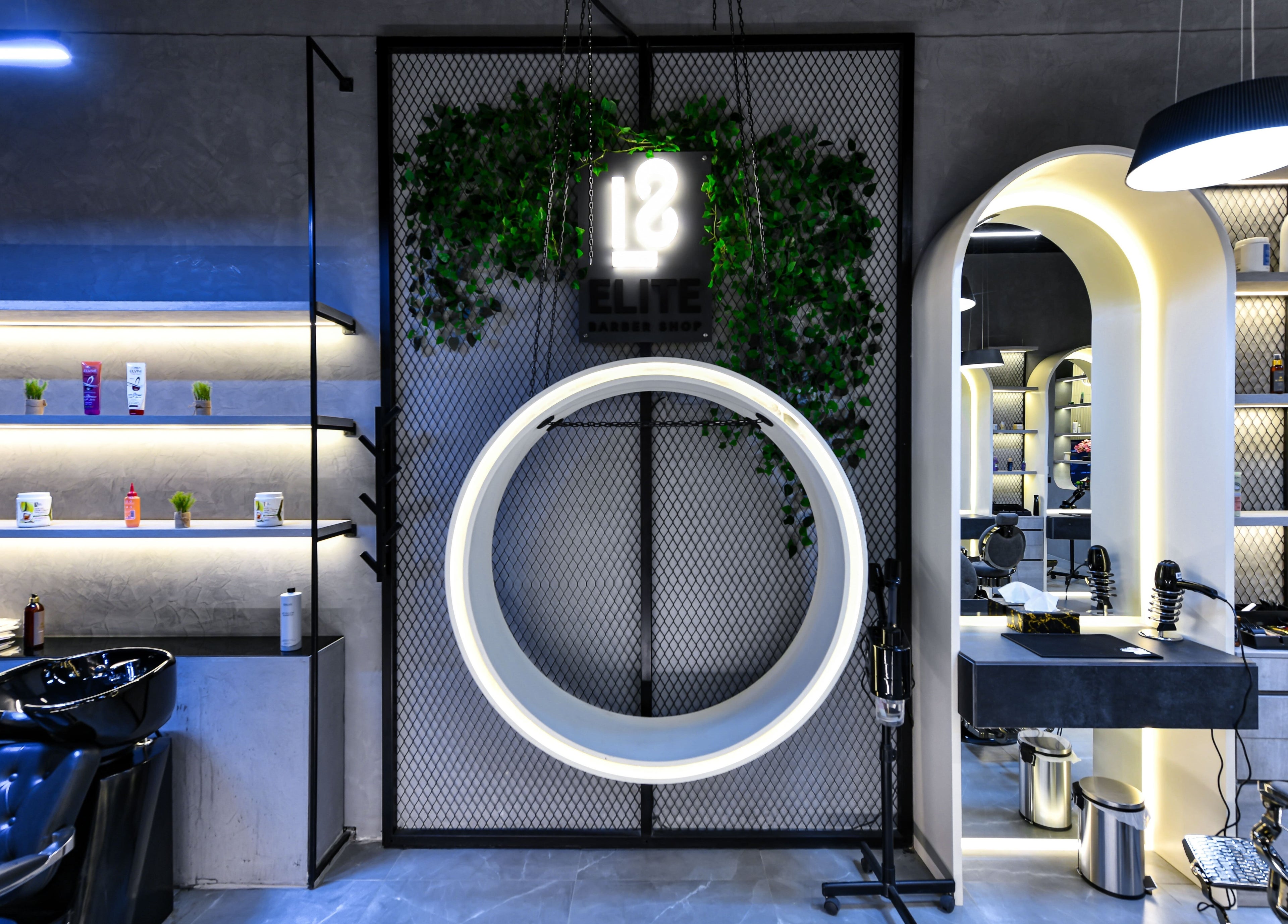 Interior of L8 Elite Barbershop in Riyadh, featuring sleek design and modern decor with illuminated shelves.