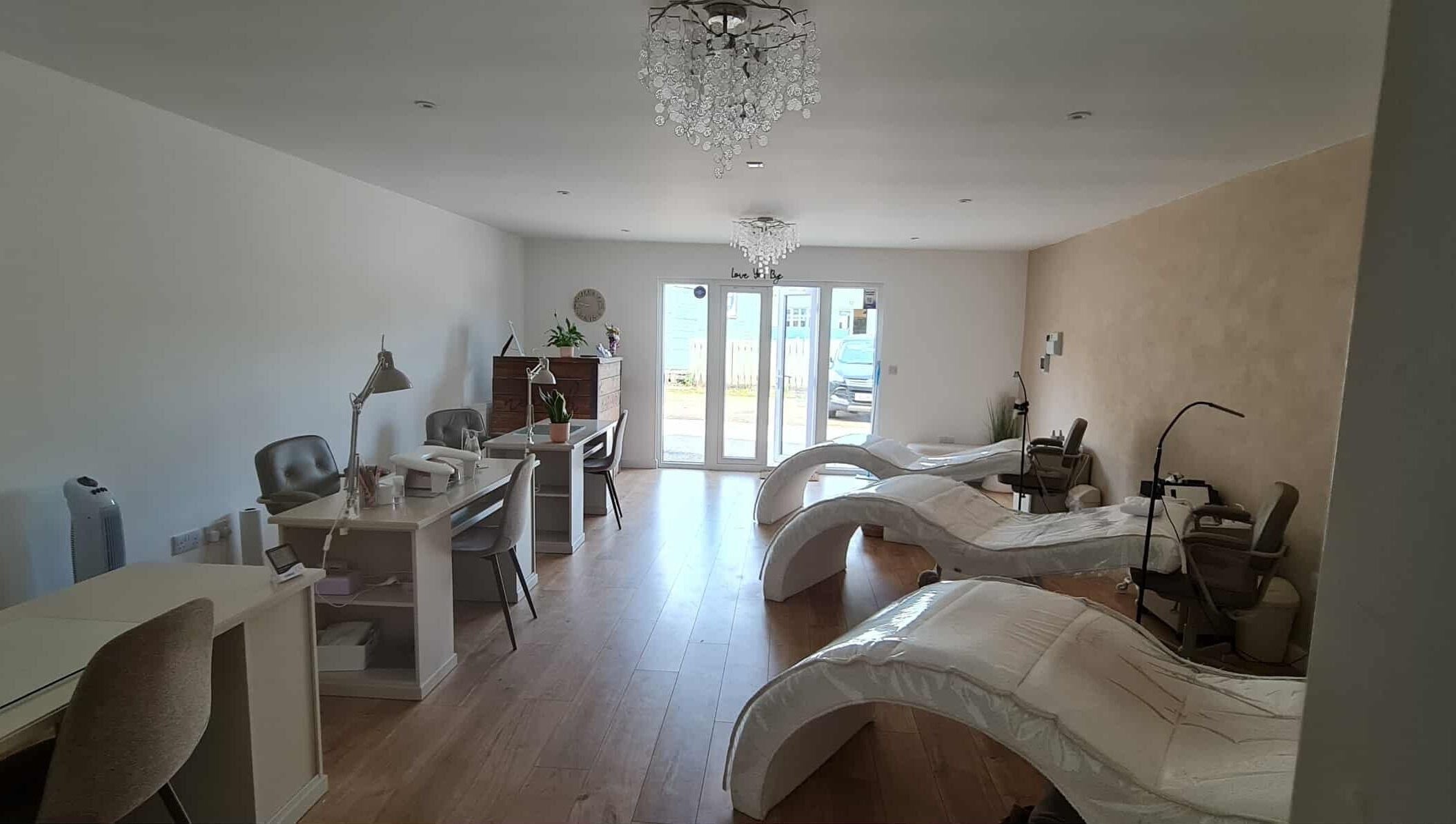 Interior view of RG Lash and Brow Artistry's serene treatment area in Par, England, GB with modern decor.