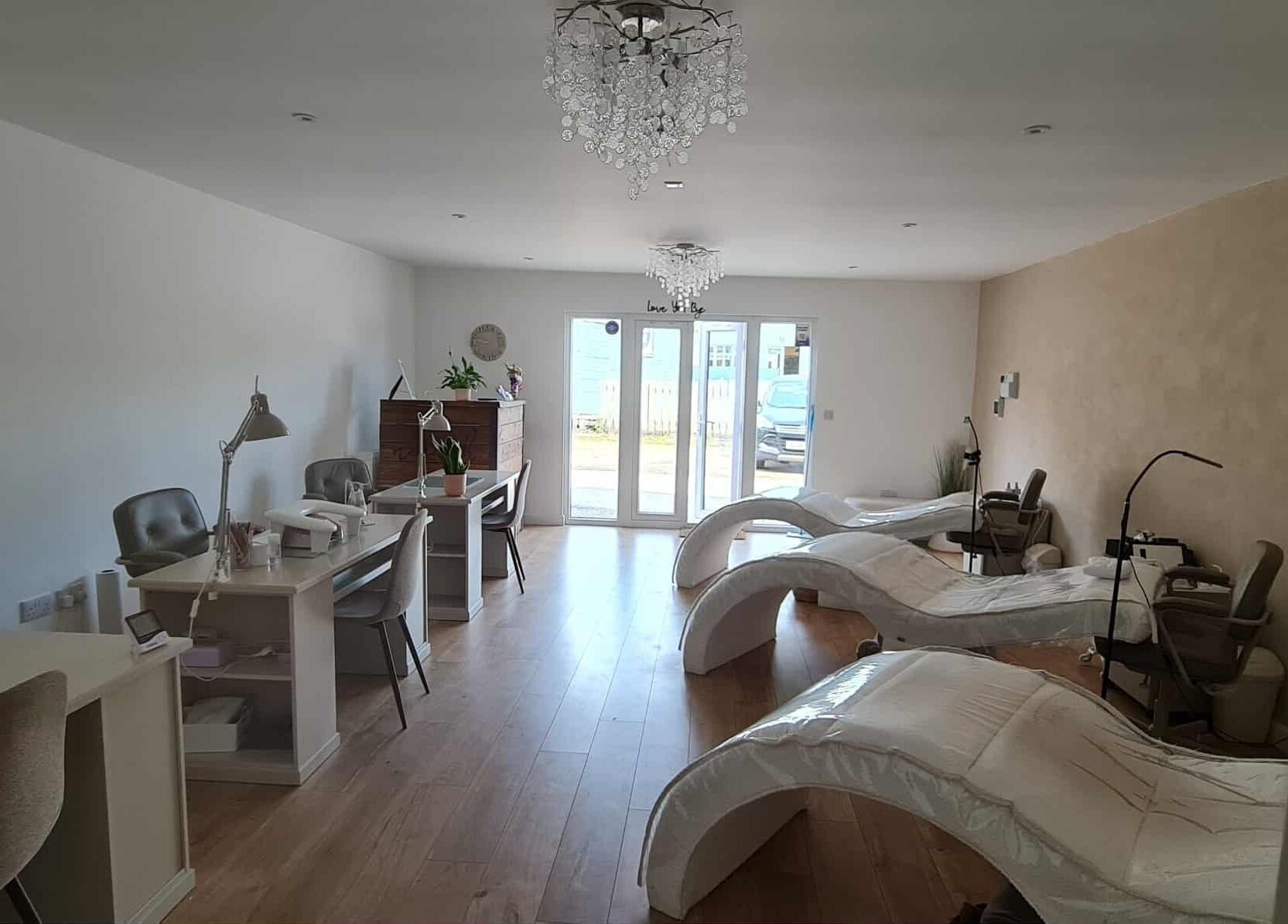 Interior view of RG Lash and Brow Artistry's serene treatment area in Par, England, GB with modern decor.