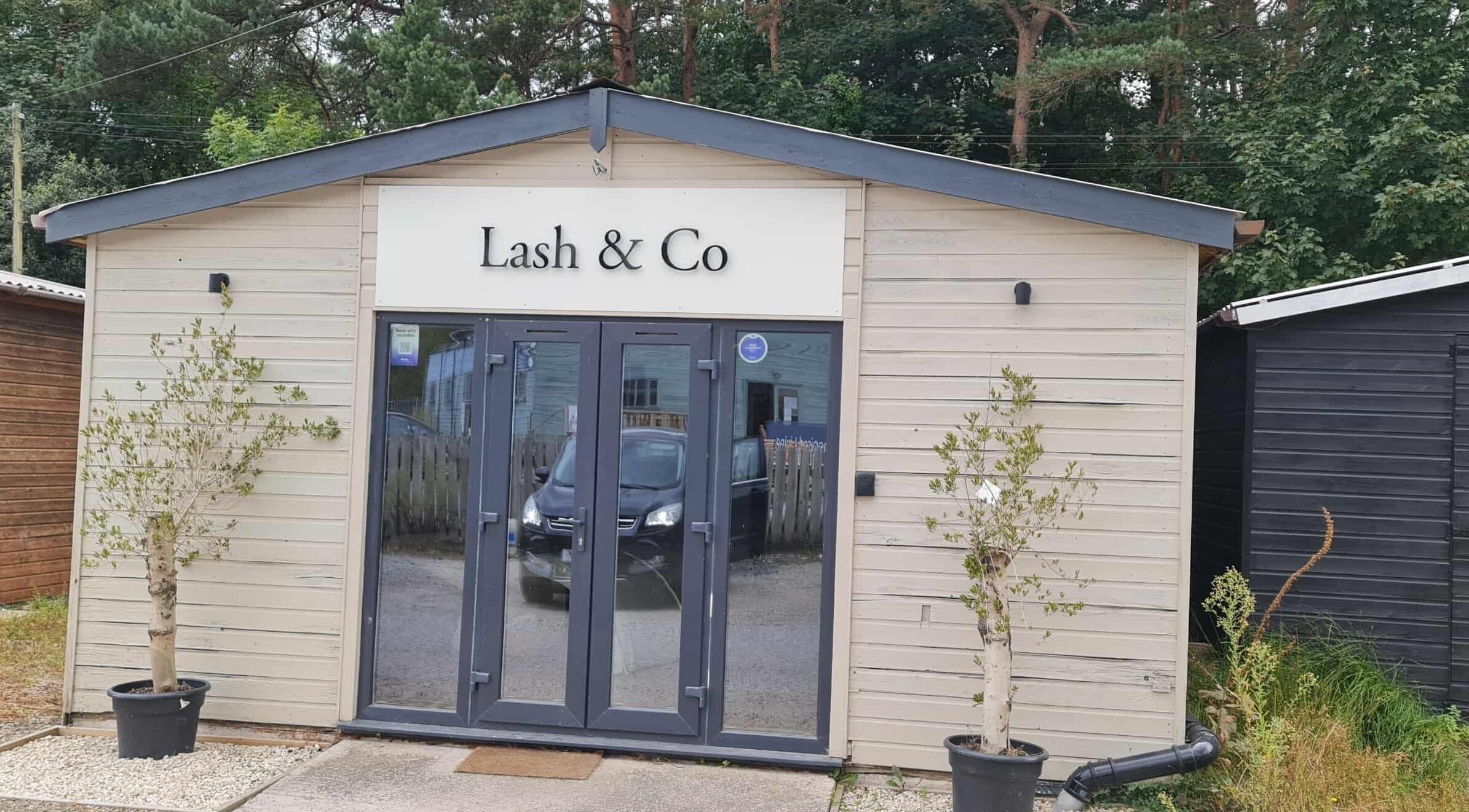 Front view of RG Lash and Brow Artistry in Par, England, GB featuring modern exterior and glass doors.
