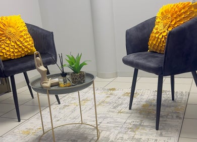 Modern seating area at BodyBlitz Therapy in Johannesburg, Gauteng, ZA with stylish decor and vibrant pillows.