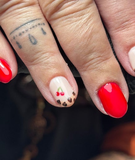 Stylish manicure with cherry and leopard designs at Nails by CG in Invergordon, Scotland, GB.