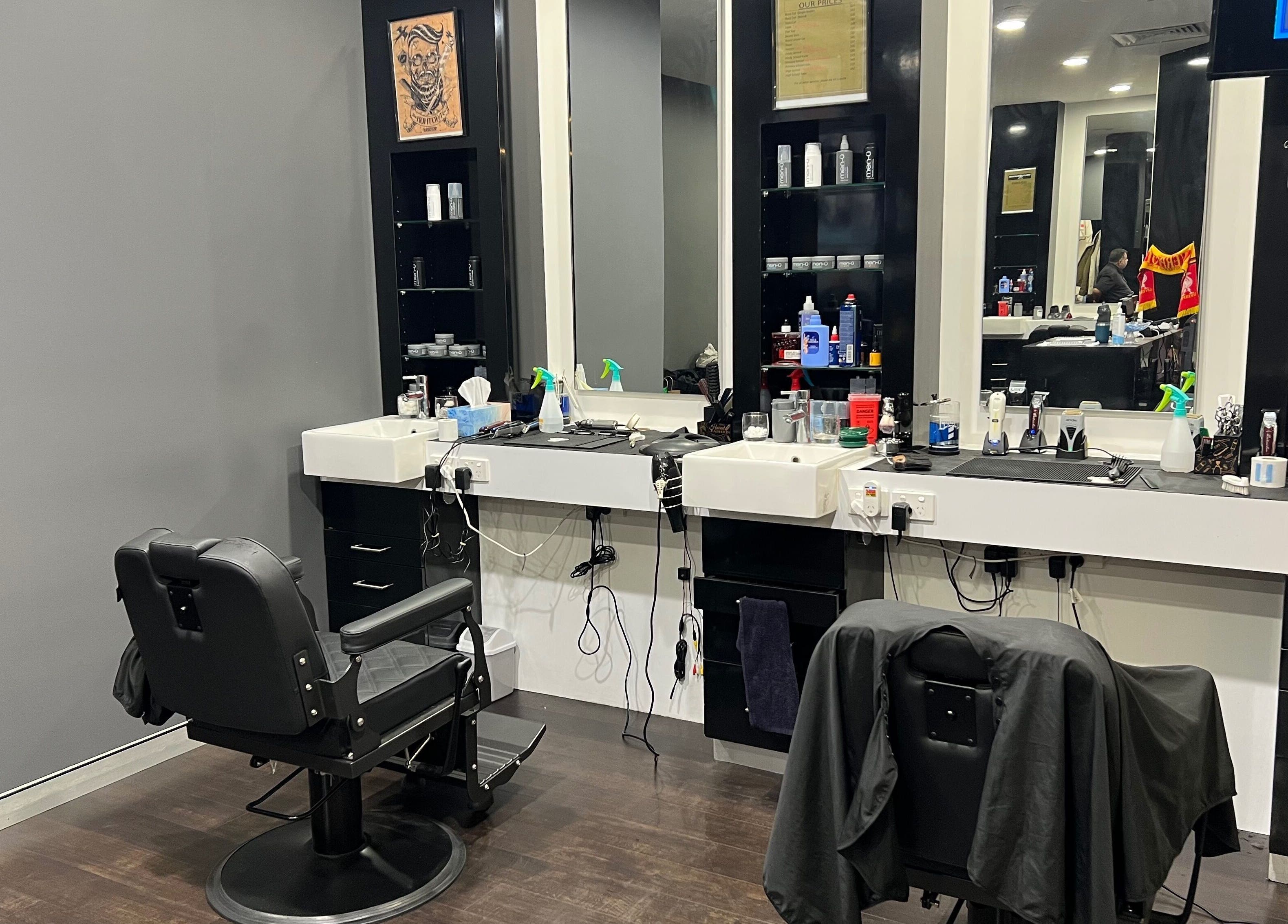 Chic interior of Cloisters - Hirani Barbers in Perth, Western Australia with stylish black chairs and sleek mirrors.