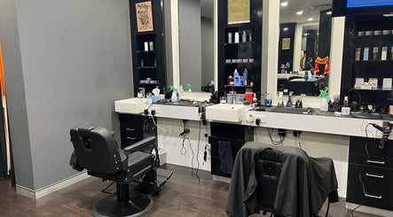 Chic interior of Cloisters - Hirani Barbers in Perth, Western Australia with stylish black chairs and sleek mirrors.