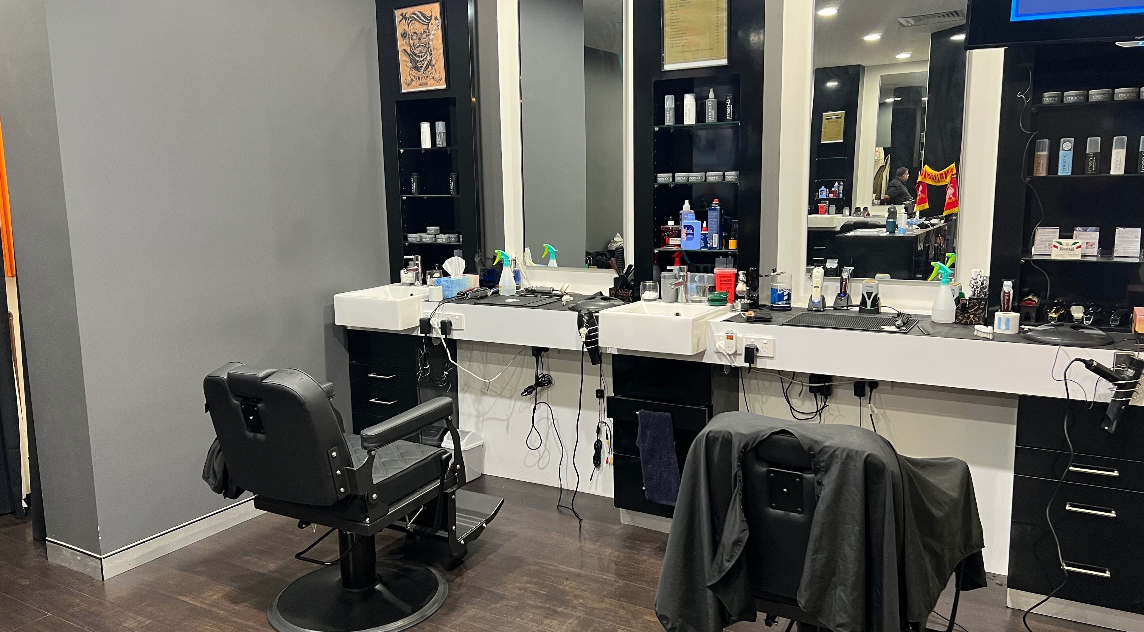 Chic interior of Cloisters - Hirani Barbers in Perth, Western Australia with stylish black chairs and sleek mirrors.
