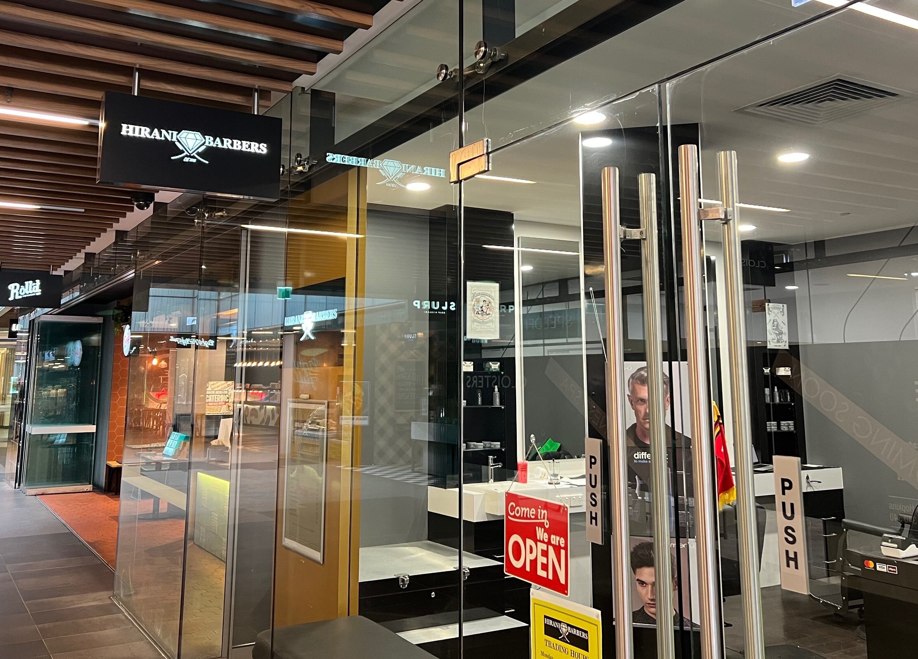 Exterior view of Cloisters - Hirani Barbers in Perth, Western Australia, AU, showcasing the sleek storefront.