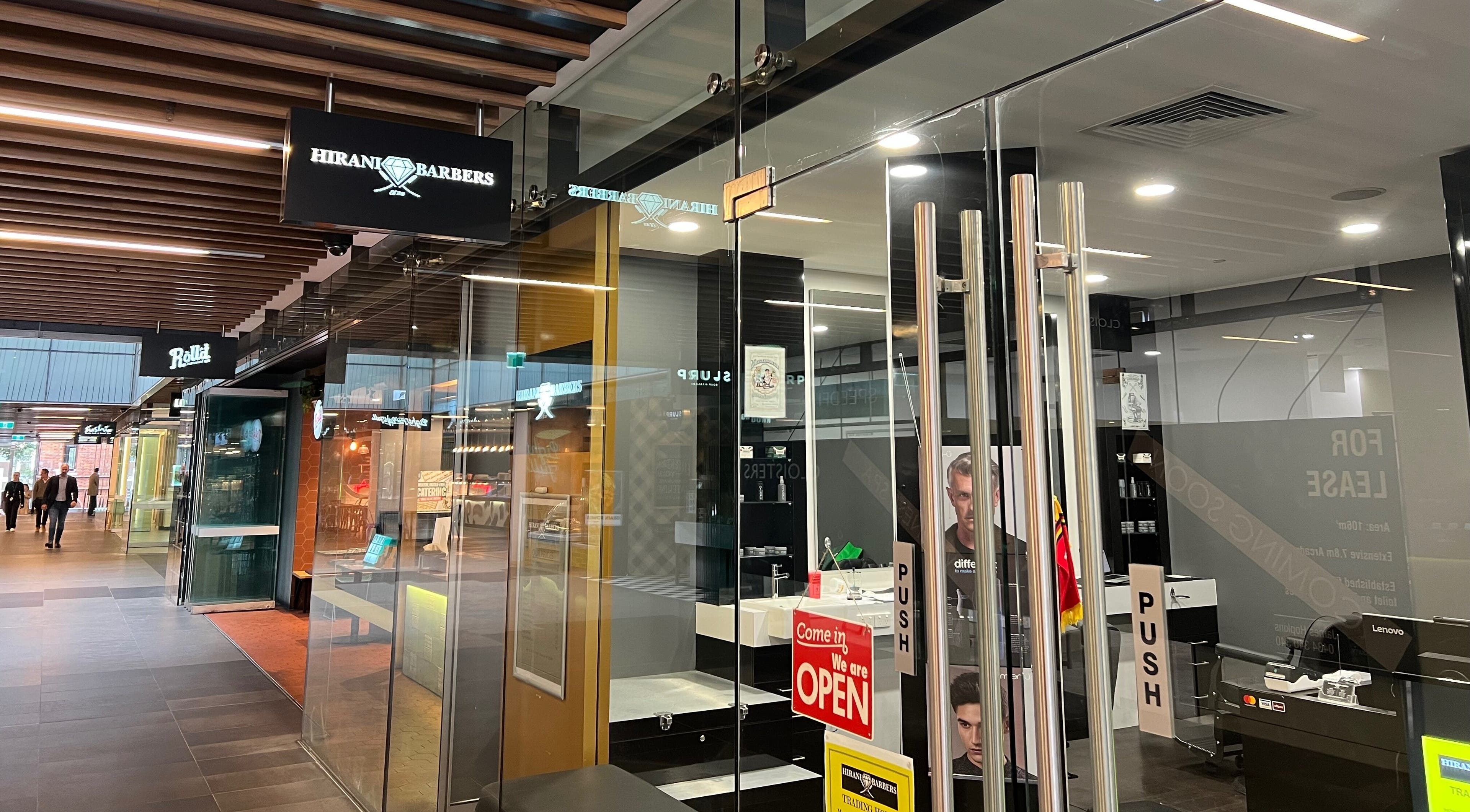 Exterior view of Cloisters - Hirani Barbers in Perth, Western Australia, AU, showcasing the sleek storefront.