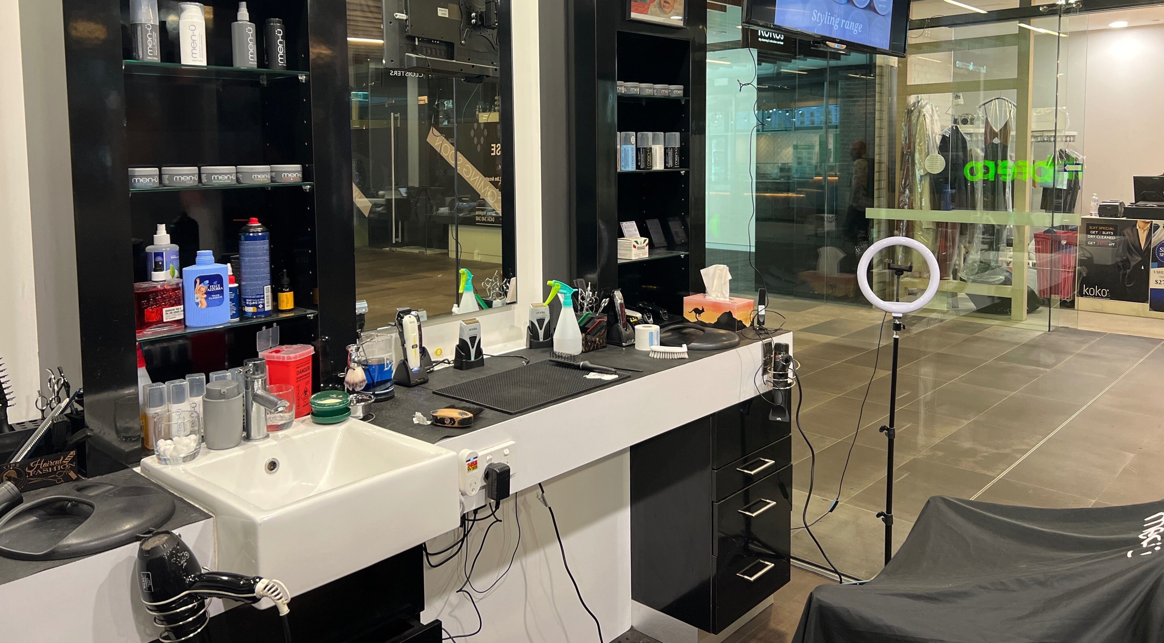 Cloisters - Hirani Barbers in Perth, Australia, showcases a well-stocked grooming station and modern barber chair.