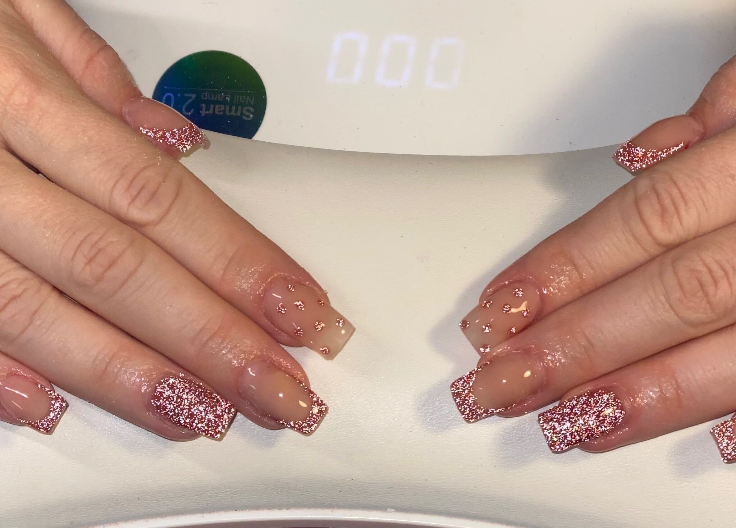 Glittery nude manicure at ONYX Nails & Beauty, Worsley, England, GB, showcasing delicate pink sparkle.