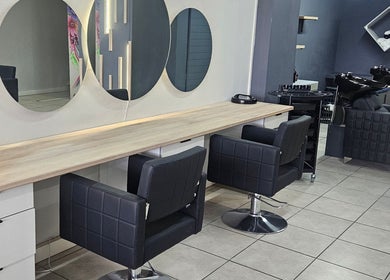 Sleek modern salon interior at Belle Vee Hair and Beauty Studio, George, Western Cape, ZA, featuring stylish chairs.