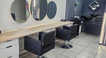 Sleek modern salon interior at Belle Vee Hair and Beauty Studio, George, Western Cape, ZA, featuring stylish chairs.