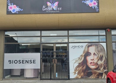 Front view of Belle Vee Hair and Beauty Studio in George, Western Cape, ZA, showcasing hair product ads.