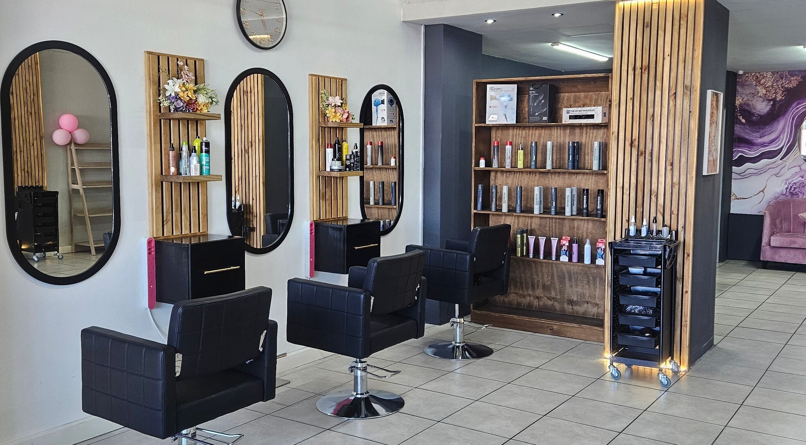 Chic, modern interior of Belle Vee Hair and Beauty Studio in George, Western Cape, ZA featuring salon chairs and mirrors.